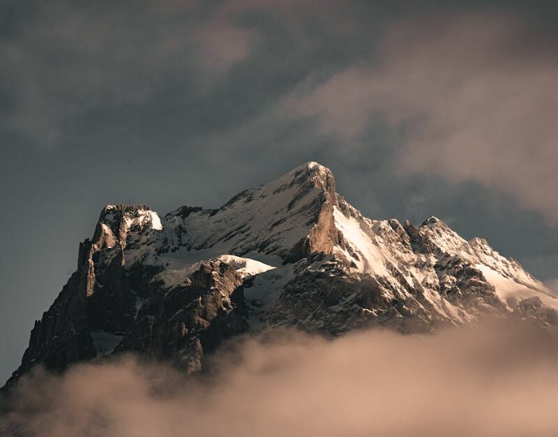 Mountain Landscapes - A stunning snow-covered mountain peak rises thro #11364091