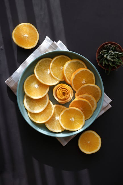 Food Aesthetics - Sliced oranges arranged in a blue plate with sha #14692495