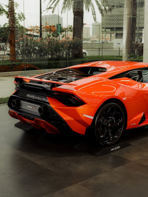 Luxury Cars - Rear view of an orange sports car in an upscale  #17632111