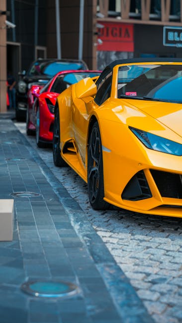 Luxury Cars - Yellow and red luxury sports cars parked on urba #18187178
