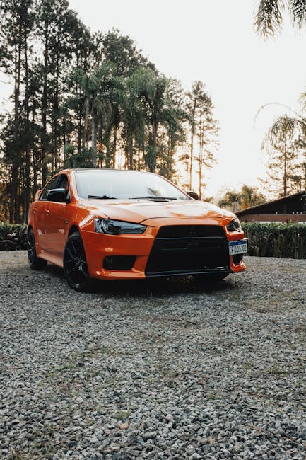 Luxury Cars - Orange Mitsubishi Lancer Evolution X parked on g #24017316