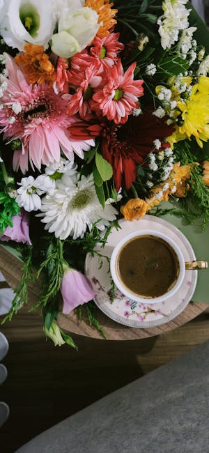 Flowers & Plants - Vibrant floral bouquet with coffee on a wooden t #27827682