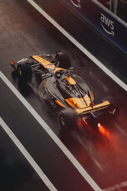 Luxury Cars - Formula 1 car speeding on a wet track during a r #31204632
