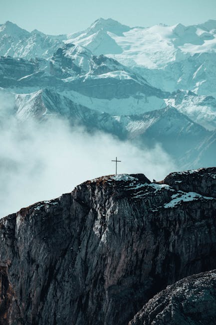 Mountain Landscapes - Stunning view of Swiss Alps with cross atop a ro #34090351