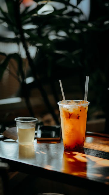 Food Aesthetics - Chilled iced tea beside a smaller drink on a sun #35137083