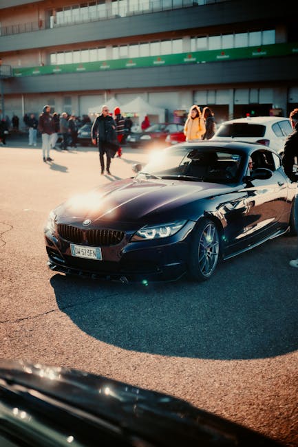 Luxury Cars - Black sports car parked at an outdoor auto show  #35403719