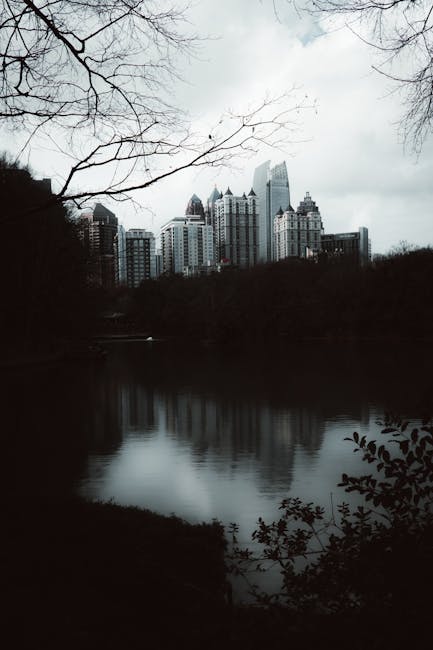 City Architecture - Moody city skyline with a lake reflection on an  #35420320