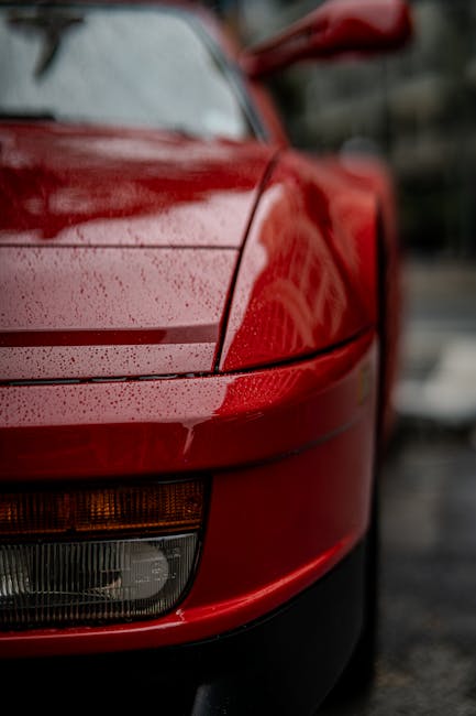 Luxury Cars - Raindrops on a red sports car's front, captured  #36830665