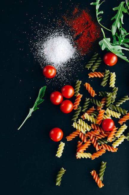 Food Aesthetics - Flatlay of uncooked pasta, cherry tomatoes, and  #5794880