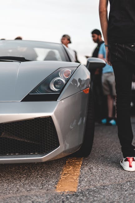 Luxury Cars - Close-up of a sleek luxury sports car with a gro #7395199