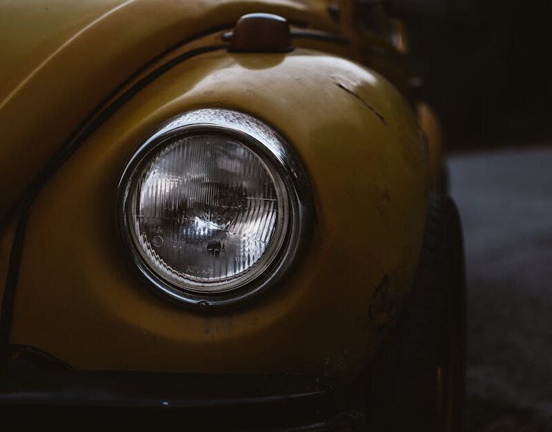Luxury Cars - A detailed close-up of a vintage yellow Volkswag #9982132